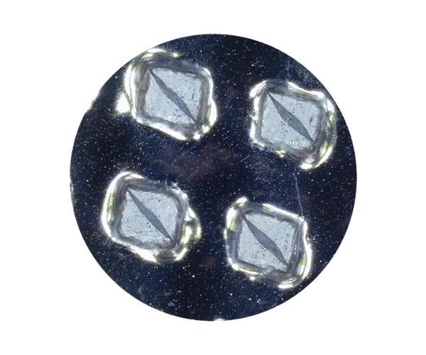 Four diamonds arranged in a circular pattern on a black background, creating a striking geometric design.