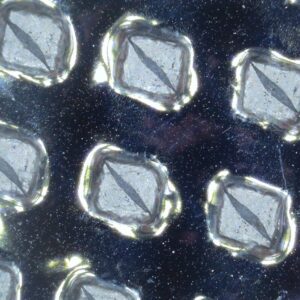 Microscopic close-up of Phase Change Material cells with crystal-like structures in a metallic surface, which helps with temperature excursions during cold chain logistics