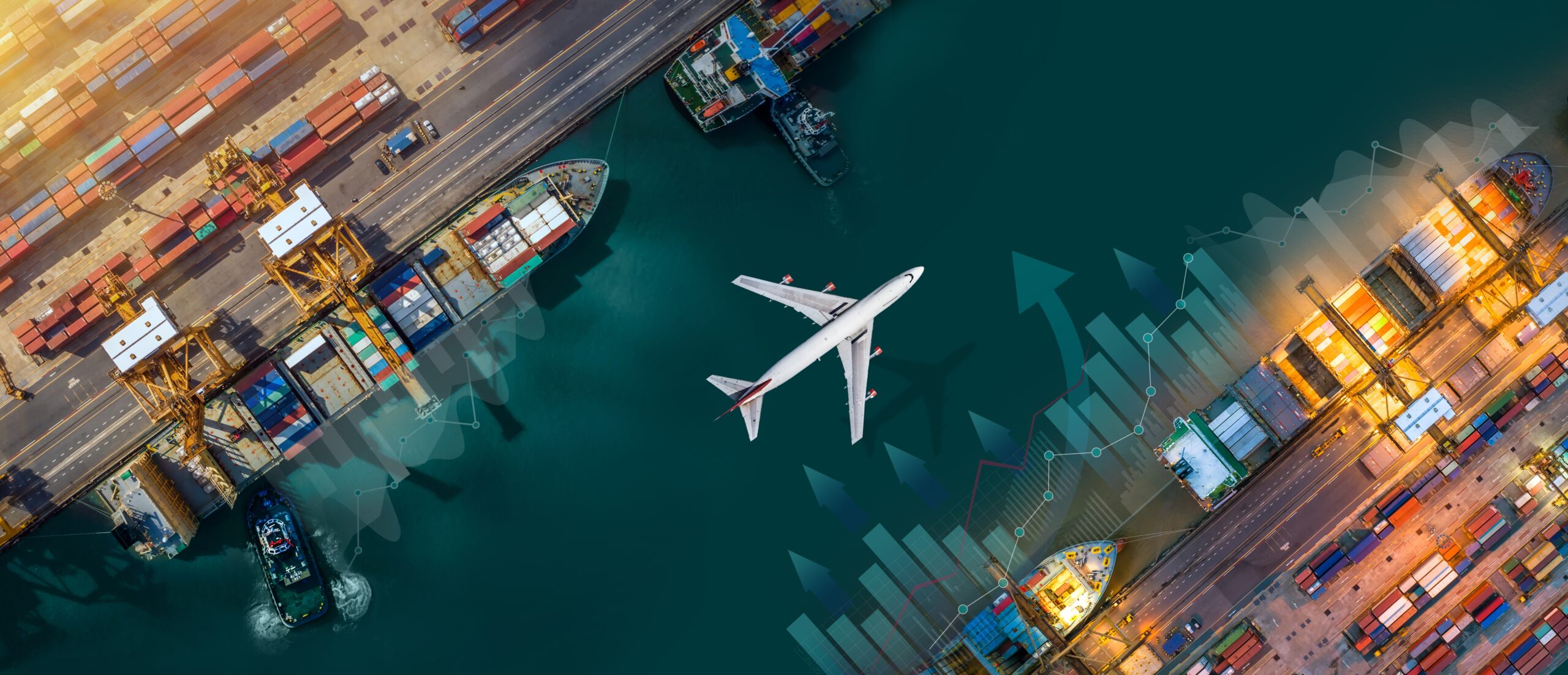 Aerial view of cargo ships at a port and an airplane flying above, illustrating global temperature controlled freight and shipment logistics.